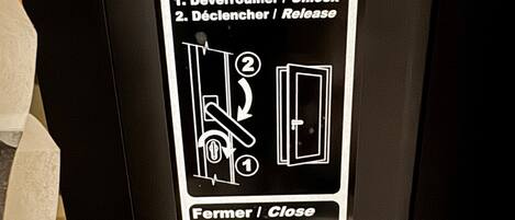 Une affiche indiquant les instructions pour l’utilisation d’une porte-fenêtre donnant sur une terrasse, y compris les étapes à suivre pour l’ouvrir et la fermer.