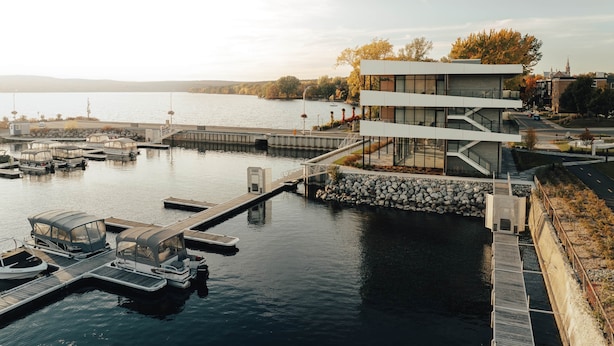 A modern building with a dock and boats.
