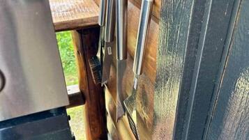 A wooden door with metal handles and a grill unit with a 'PERFORMANCE' label.