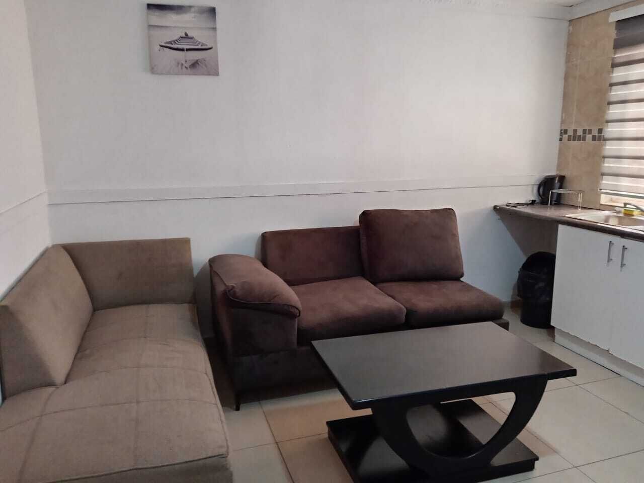 A small living area with a sofa, a loveseat, and a coffee table.