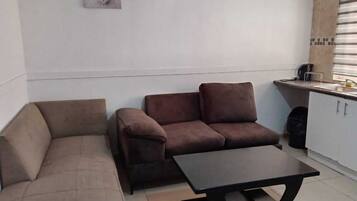 A small living area with a sofa, a loveseat, and a coffee table.