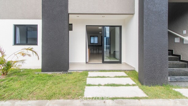 A modern building with a flat roof, large glass doors, and a visible interior with a dining area. - Apartments With Swimming Pool 700m From Taperapuan Beach Nvm0009 (Porto Seguro)