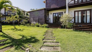 A two-story building with a well-maintained lawn, stone steps leading to the entrance, and a balcony with dark railings. - House With a Pool 5 Minutes From the Beach Cmv004 (Maraú)