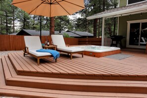A wooden deck with two lounge chairs and a hot tub. - Forest Retreat at Canyon Loop (Flagstaff)