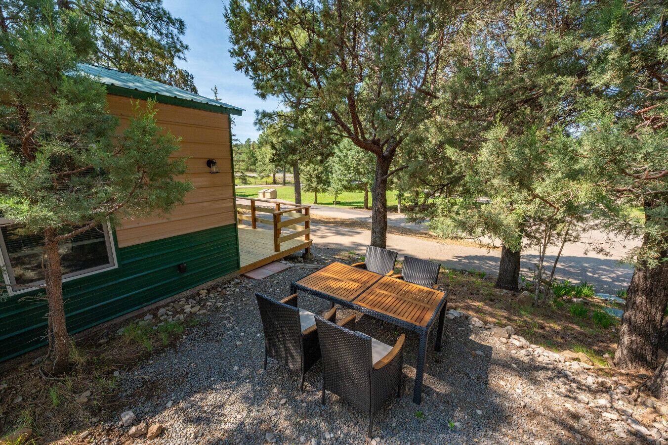 A small cabin with a deck and outdoor seating area.