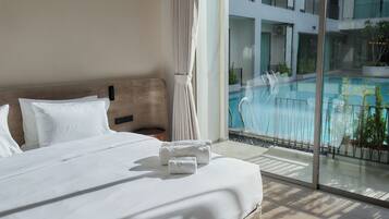 Deluxe Double Room, Pool View | In-room safe, desk, laptop workspace, blackout curtains