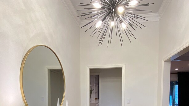 A modern bathroom with a vanity, mirror, and a unique ceiling light fixture. - Welcoming 4-bedroom house in vibrant Buckhead Atlanta (Atlanta)