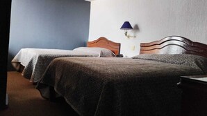 A hotel room with two single beds, a nightstand, a lamp, and a wall-mounted light fixture. - Hotel Guadalupe Express (Guadalupe)