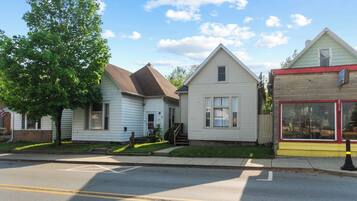 A row of residential houses with a clear street in front.