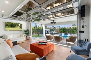 TV, fireplace, books - Luxe Haven with Poolside Lounge & Stunning Aquarium Floors (Scottsdale)