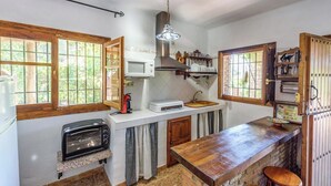 A compact kitchen with a built-in microwave, toaster, and sink. - La Terrera Órgiva by Ruralidays (Granada)