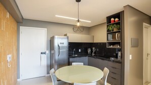 A modern kitchen with a central island, built-in appliances, and a hanging light fixture. - Apt With Pool 200m From the Beach Skc0414 (Maceió)