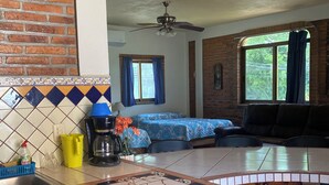 A kitchen with a tiled backsplash, a coffee maker, and a sink. - La Brisa - Large Studio Suite (Punta de Mita)