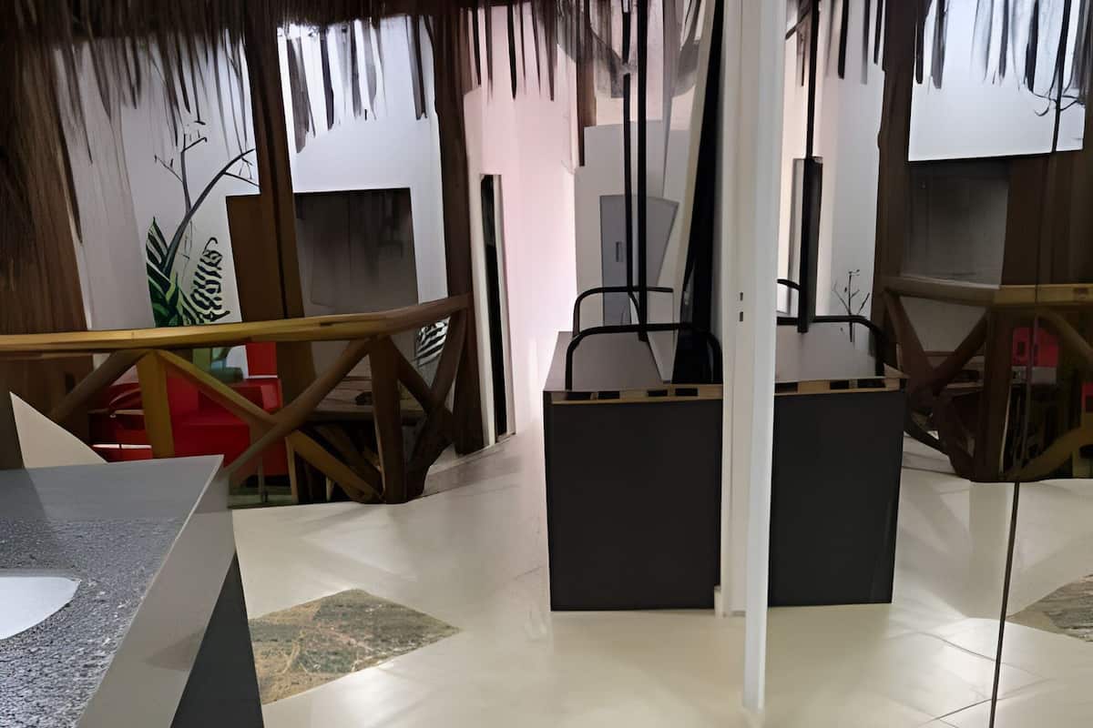 A modern interior with geometric floor tiles, a reception desk, and a view of the outside.