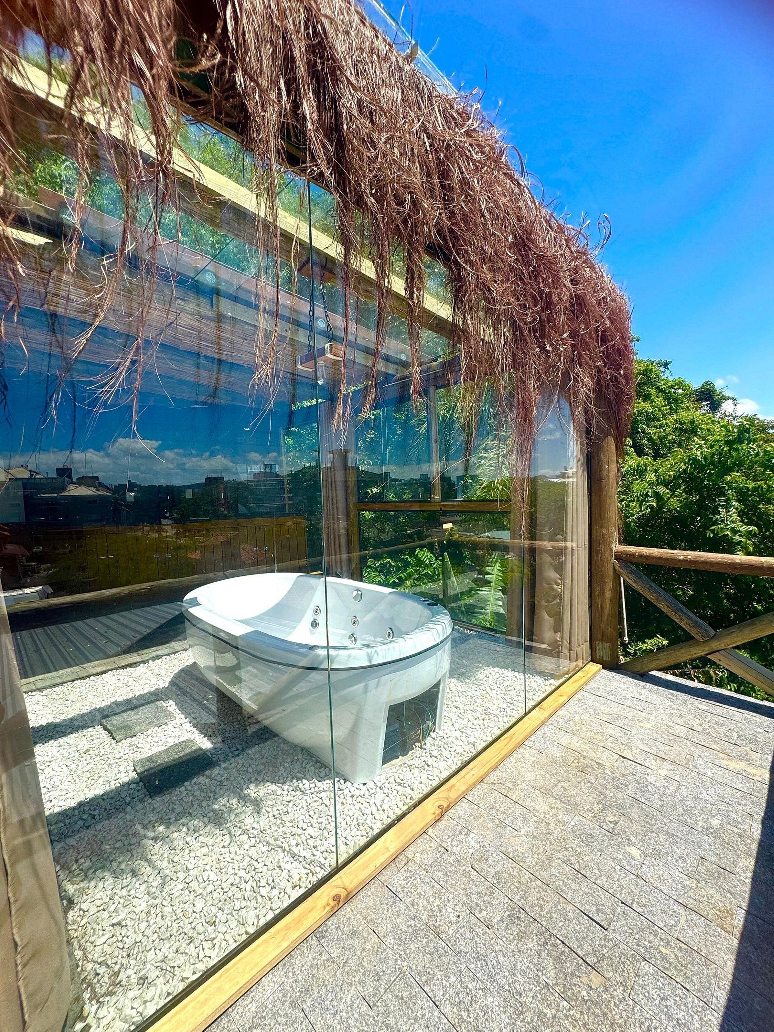 A glass-enclosed hot tub with a clear view of the surrounding area.