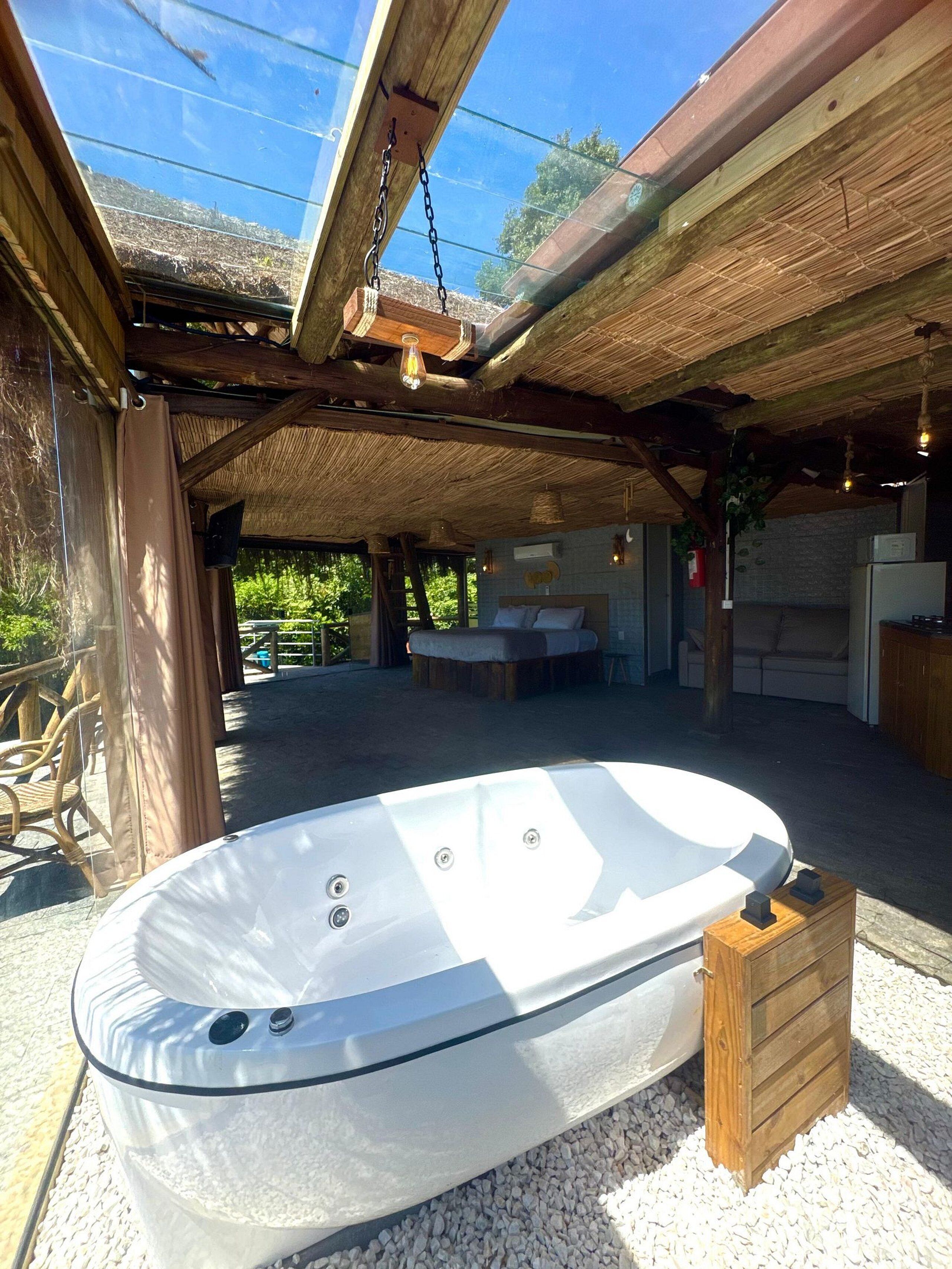A spa area with a hot tub, wooden beams, and a glass ceiling.
