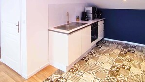 A compact kitchen with a sink, microwave, and oven.
