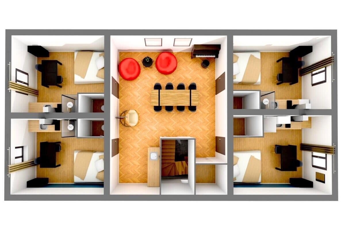 Indeling van een hotelkamer met een bed, bureau, stoel en een zithoek met twee rode stoelen.