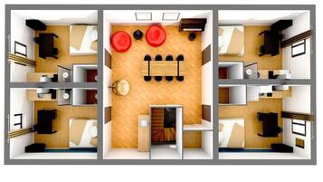 A hotel room layout with a bed, desk, chair, and a small seating area with two red chairs.