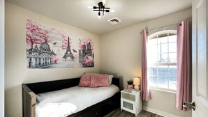A bedroom with a bed, a nightstand, a window with curtains, and a wall mural. - PARIS - 2 beds / Free garage parking / Downtown Salt Lake City (Salt Lake City)