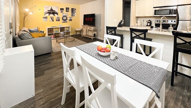 A modern living room with a dining area, a kitchen, and a cozy seating area with a sofa and a coffee table. - PARIS - 2 beds / Free garage parking / Downtown Salt Lake City (Salt Lake City)