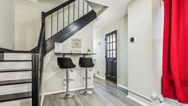 A staircase leading to a landing with two bar stools and a welcome sign. - Camden's Little Charm-Walking Distance Stadium & Convention, University of MD (Baltimore)