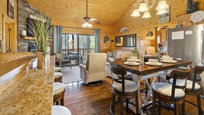 A wooden interior with a kitchen, dining area, and bar.