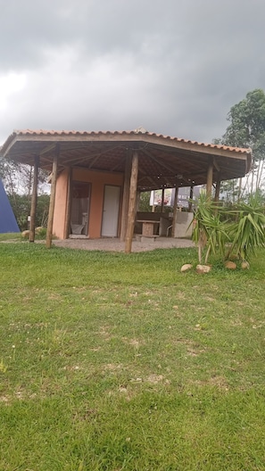A single-story building with a tiled roof and a covered patio area.