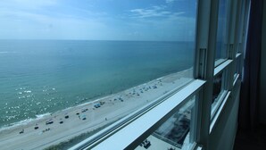 Vista de la playa desde un edificio alto, bajo un cielo despejado.
