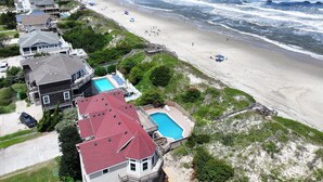 A coastal residential area with houses, a beach, and a swimming pool. - OCEANFRONT, priv pool & Hot Tub, Rec Room-WL1011, Sea Esta (Corolla)