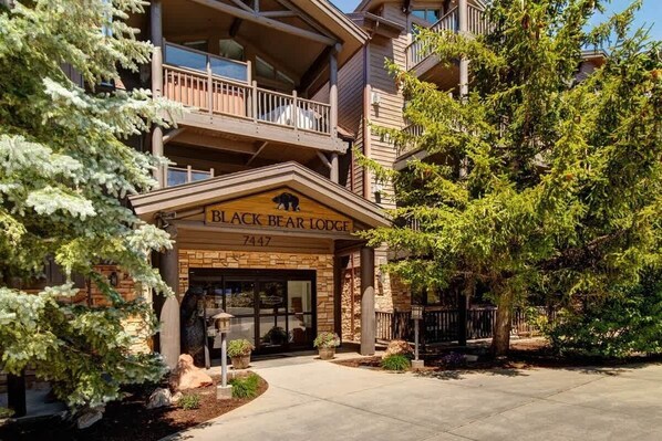 A multi-story building with a sign reading 'Black Bear Lodge' and the number '7447'. - Abode at Black Bear #330, hot tub, pool table, steps to Deer Valley (Park City)
