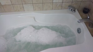 A bathtub filled with water and bubbles.