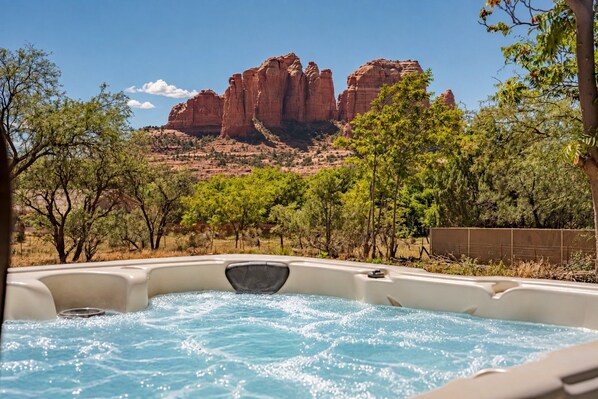 A hot tub with a view of red rock formations.