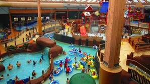 An indoor water park with multiple pools, slides, and play structures. - Family Base Camp + 5BR + Game Room + Hot Tub (McGaheysville)