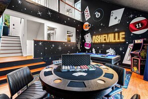 A room with a pool table, poker chips, playing cards, and a neon sign. - Asheville 6BR Retreat — Bowling Alley, Hot Tub, Sauna, Theater —  Sleeps 16 (Asheville)