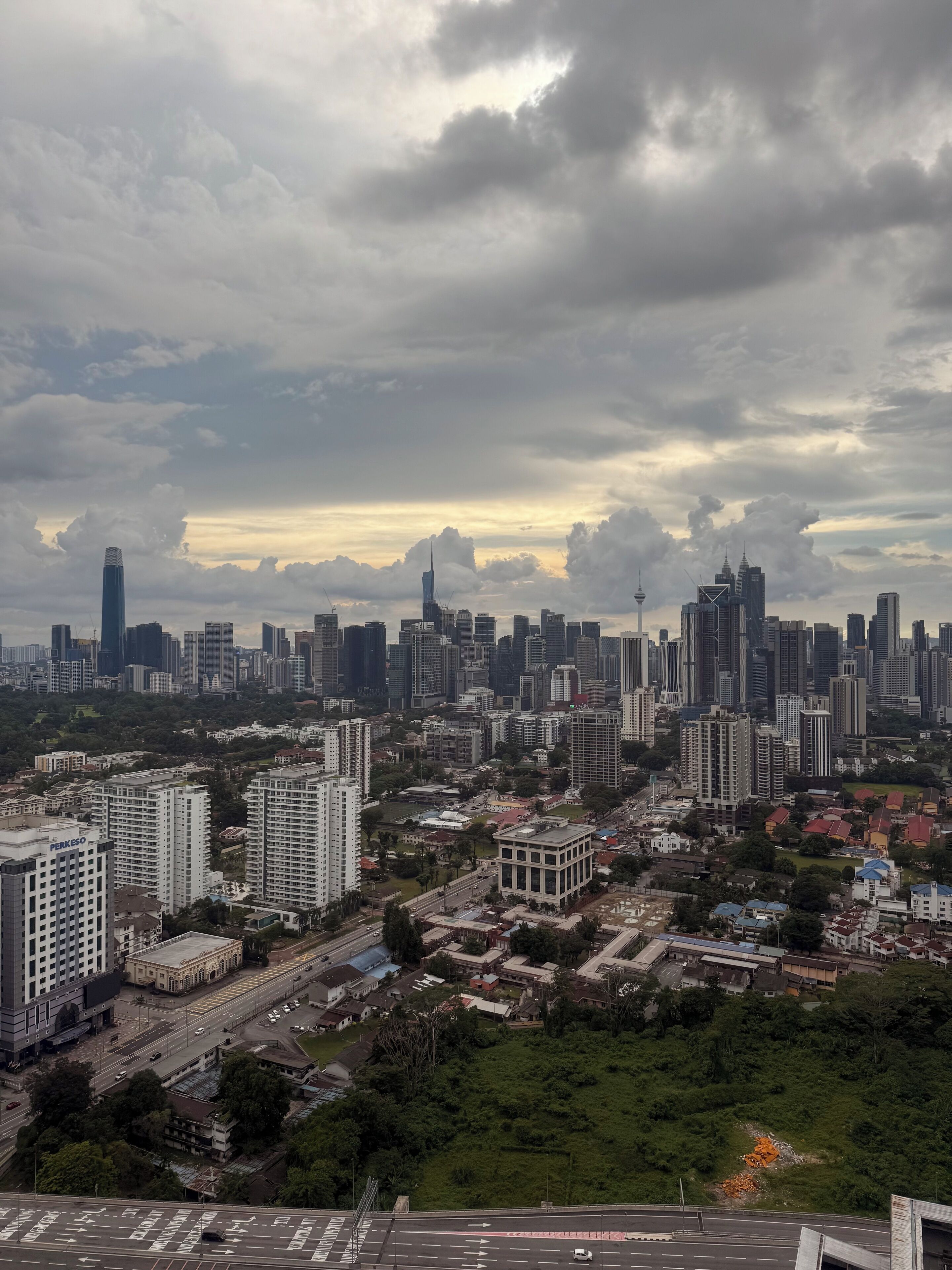 A cityscape with high-rise buildings, a prominent tower, and a mix of residential and commercial structures.