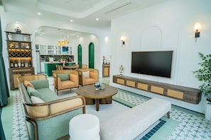 Deluxe Villa, 3 Bedrooms, Garden View | Living area | 60-inch LED TV with cable channels, streaming services