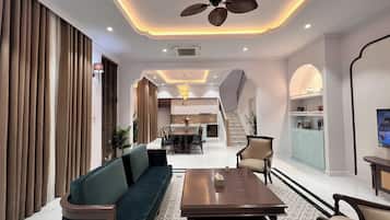 Deluxe Villa, 4 Bedrooms, Balcony, Garden View | Living area | 60-inch LED TV with cable channels, streaming services