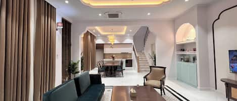 Deluxe Villa, 4 Bedrooms, Balcony, Garden View | Living area | 60-inch LED TV with cable channels, streaming services