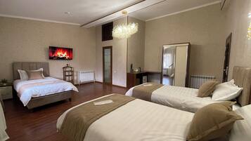 Deluxe Triple Room, Garden View | In-room safe, laptop workspace, blackout curtains, soundproofing