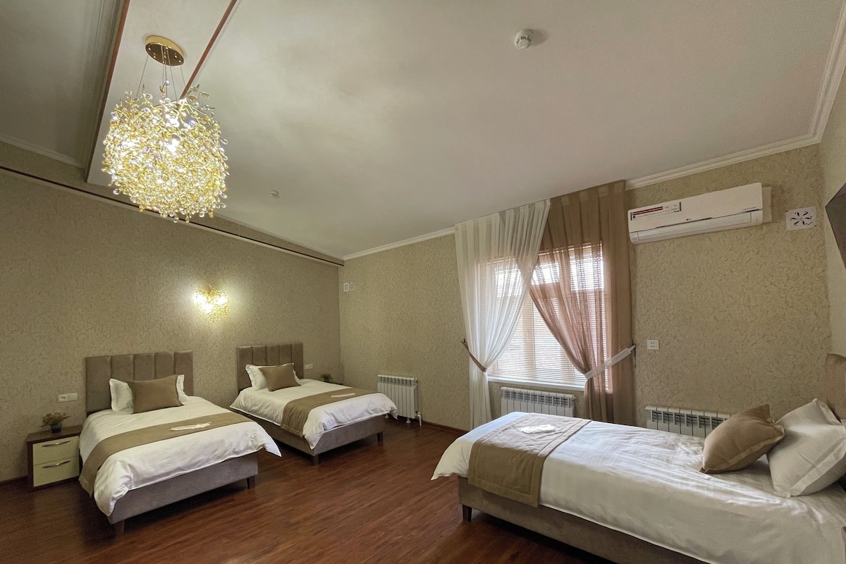Deluxe Triple Room, Garden View | In-room safe, laptop workspace, blackout drapes, soundproofing