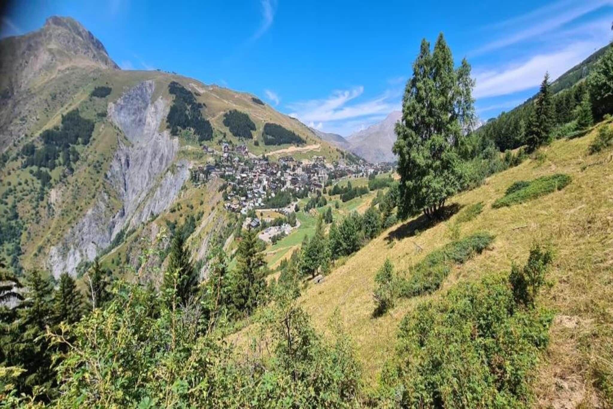 A mountainous landscape with a small village nestled in a valley.