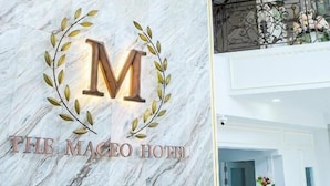 A marble wall with a logo and the text "THE MACEO HOTEL". - The MACEO Hotel (Nong Khai)