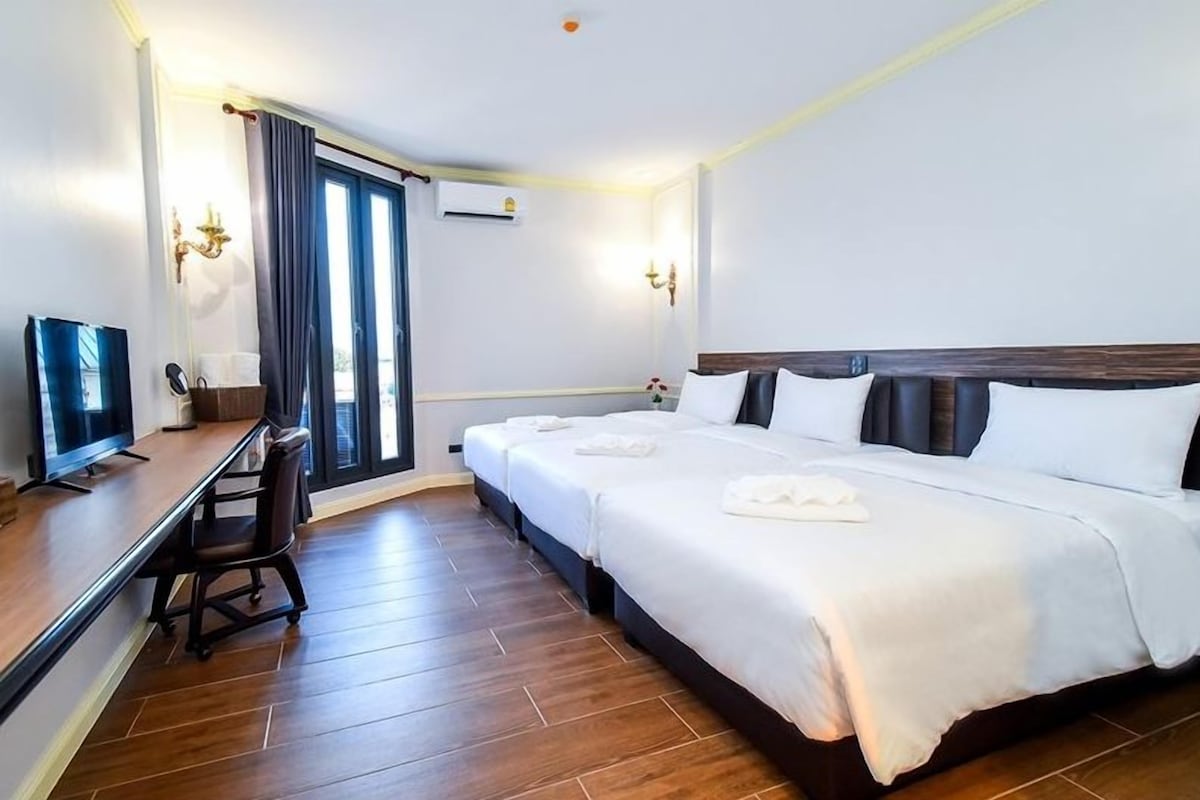 Family Triple Room, City View | Minibar (free items), desk, laptop workspace, blackout drapes