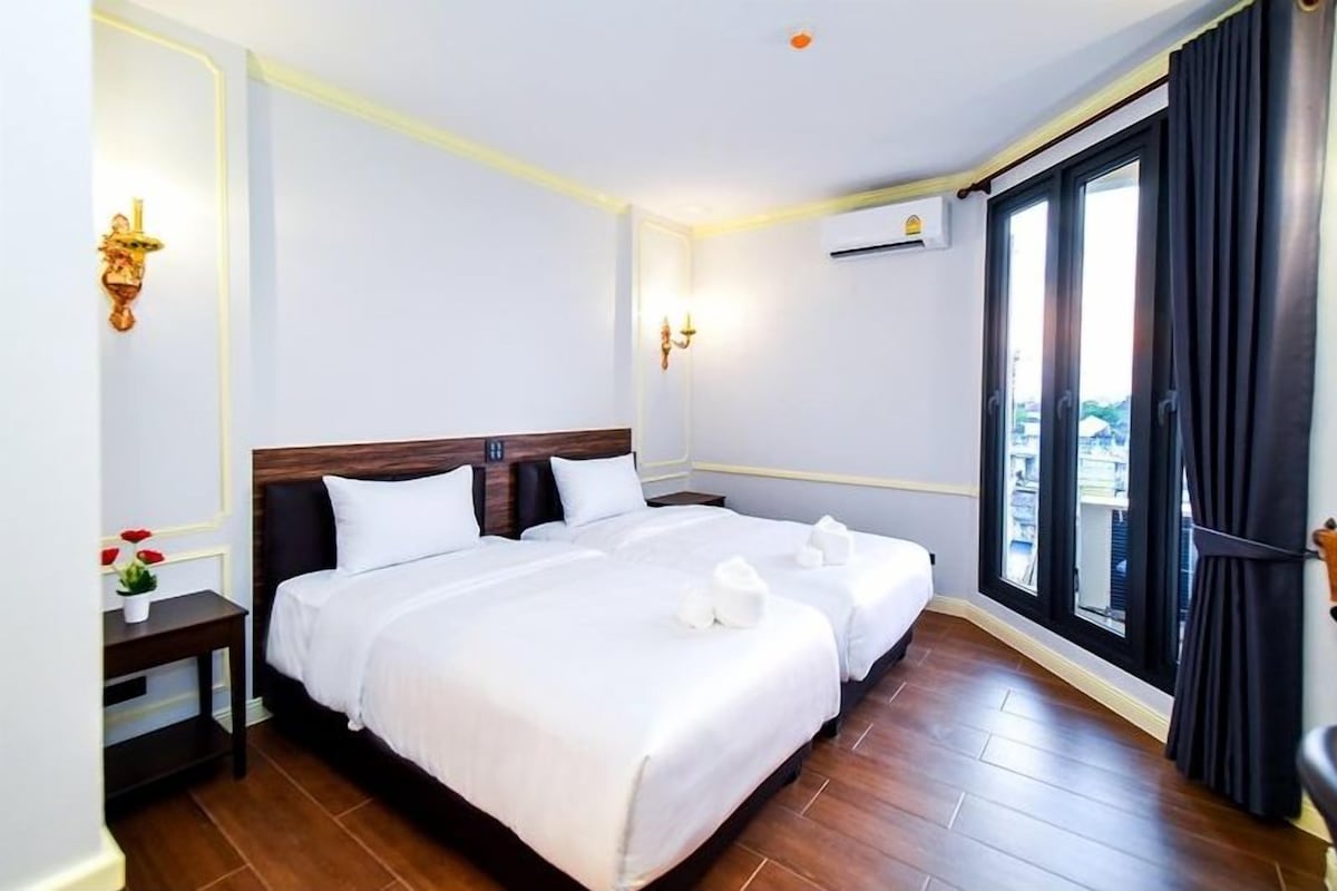 Premier Twin Room, City View | Minibar (free items), desk, laptop workspace, blackout drapes