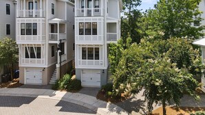 A multi-story residential building with a symmetrical facade, two-story balconies, and a central garage. - 5 Minutes to Beach|Newly Furnished Designer Home (Mount Pleasant)