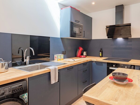 A modern kitchen with a built-in dishwasher, a microwave, and a stove.
