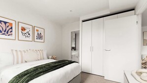 A bedroom with a bed, a wardrobe, and a nightstand.