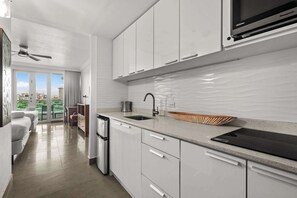 Fridge, microwave, coffee/tea maker, cookware/dishes/utensils