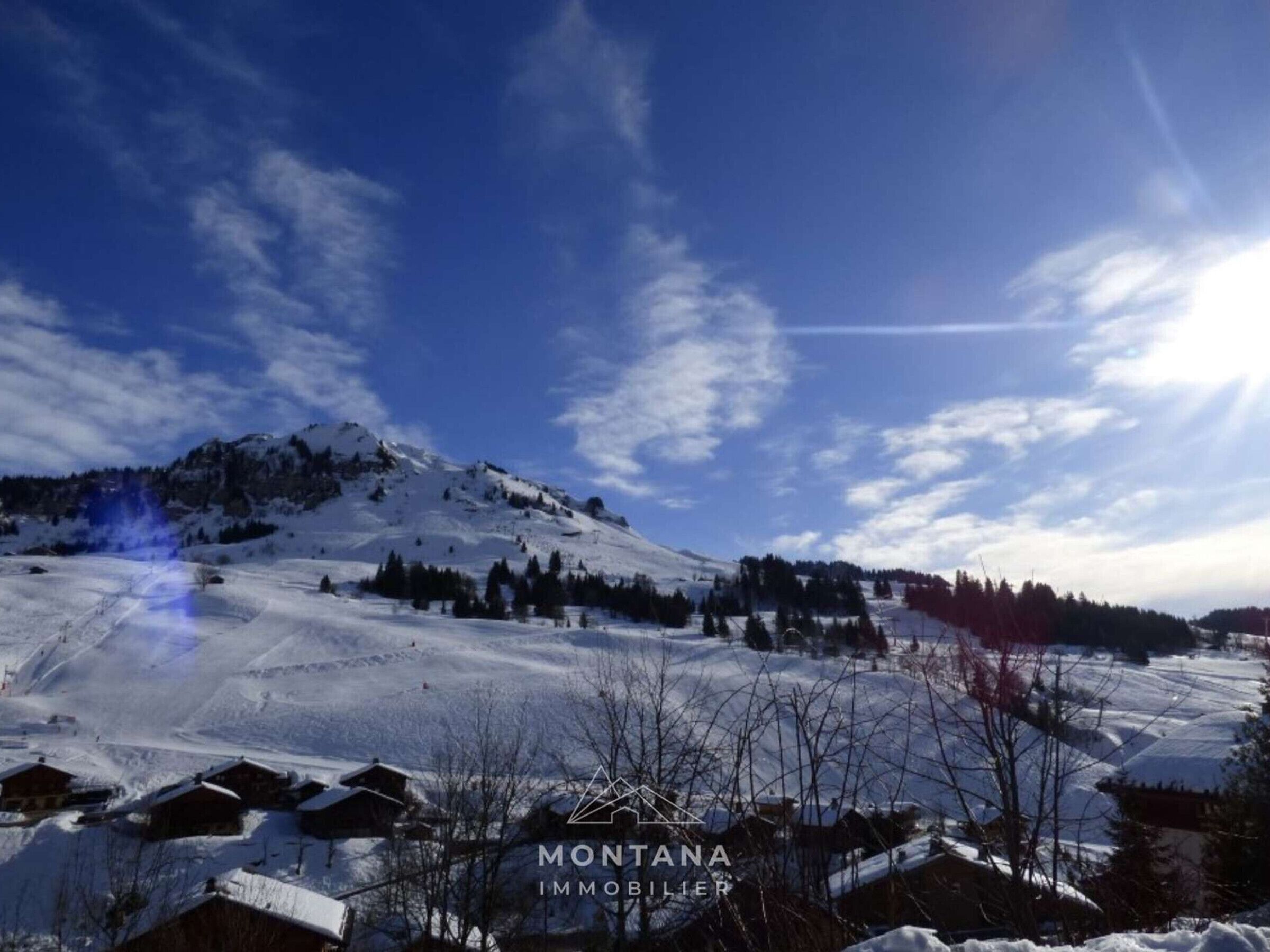 A snow-covered mountainous landscape with a clear sky.
